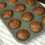 Baking pan of easy Bran and Raisin Molasses Muffins on white towel