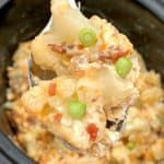 cauliflower casserole in slower cooker loaded with bacon and cheese