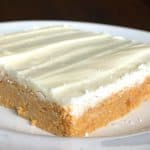 peanut butter and white chocolate bar on a white plate with dark background