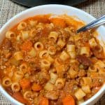 bowl of Italian sausage and pasta soup with ditalini and vegetables