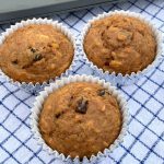 3 oatmeal raisin all bran muffins on a blue plaid cloth