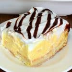 Piece of layered cream puff cake on a white plate