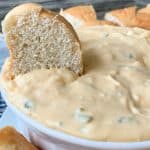 Easy bagel party dip with a piece of bagel in it