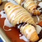 Crescent Roll Cinnamon Roll on corner of baking sheet with non-stick liner