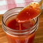 Jar of easy homemade barbecue sauce with a spoon