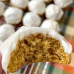 Bite out of moist pumpkin cookie with cream cheese icing