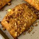 Crushed crouton seasoning on baked chicken pocket made from crescent dough
