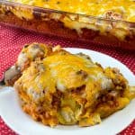 Easy sausage bubble up pizza on white plate next to casserole dish