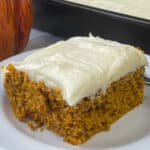 Easy pumpkin carrot cake next to pan full and a pumpkin
