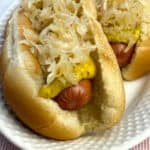 Close up sauerkraut and mustard on hot dogs