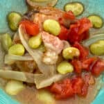 Bowl of squirrel stew with tomatoes, onions, lima beans and mushroom gravy