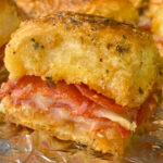 Side view of glazed pepperoni pizza slider with melted cheese on the side