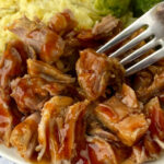Close up barbecue pork country ribs with a fork in the bite on top