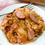 Plate of sauerkraut casserole with Kielbasa sausage, rice, tomato soup, peppers and onions