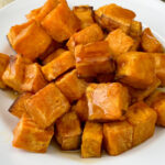 Close up pile of the best air fried sweet potato cubes with a light coating of syrup