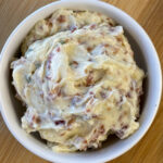 Close up creamy butter with blue cheese, bacon and herbs