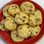 Pile of tender graham cracker chocolate chip cookies on a red plate