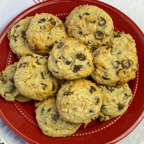 Pile of tender graham cracker chocolate chip cookies on a red plate
