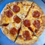 Delicious homemade stuffed crust pizza with three ingredient crust cut into 6 pieces and ready to eat.