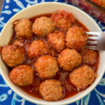 Over head view of warm and tasty sauerkraut meatballs in a white bowl.