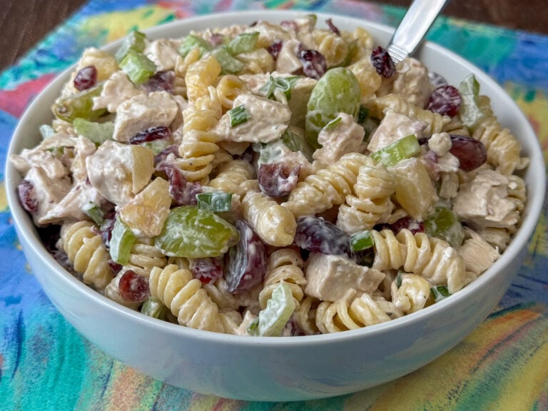 Rotini pasta coated with a simple dressing and filled with tender chicken, green and red grapes, pineapple tidbits, green onions and cashews to create a unique and fruity chicken salad recipe.
