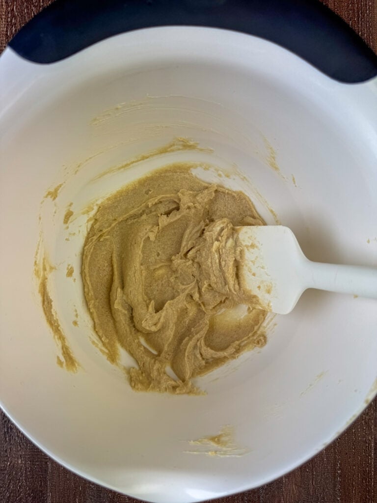 Melted brown sugar and butter stirred together in a mixing bowl.