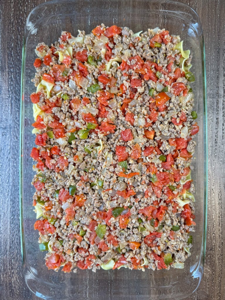 Cooked Italian sausage with chopped onion, green peppers and tomatoes spread over shredded zucchini.