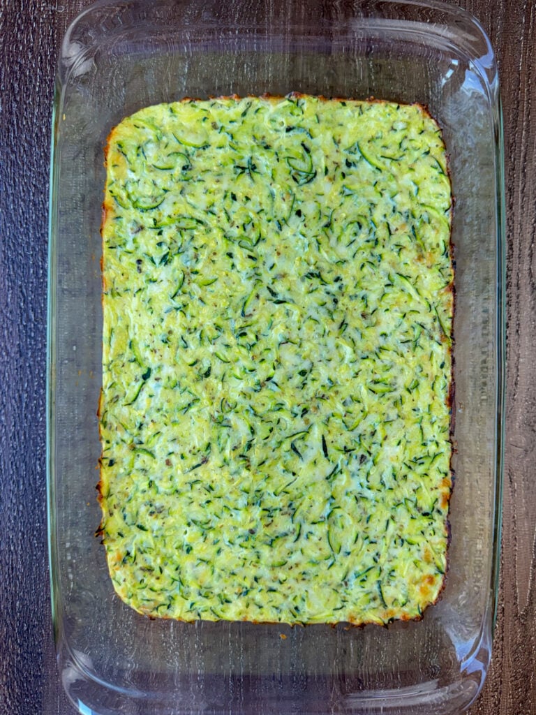 9 x 13" pan with shredded zucchini casserole base baked with eggs and cheese.