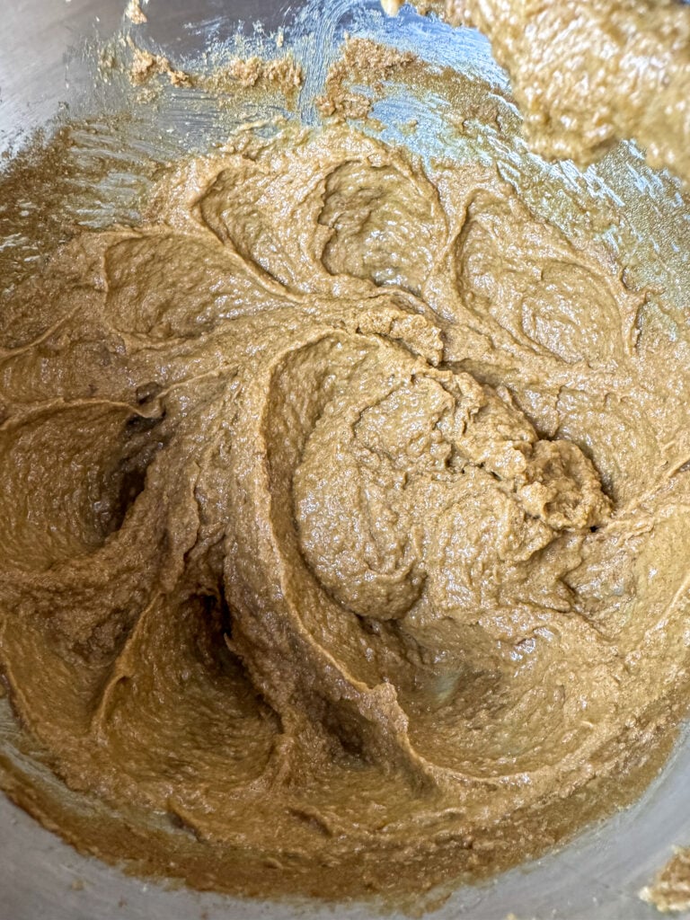 Eggs and vanilla added to dark brown sugar and butter mixture.